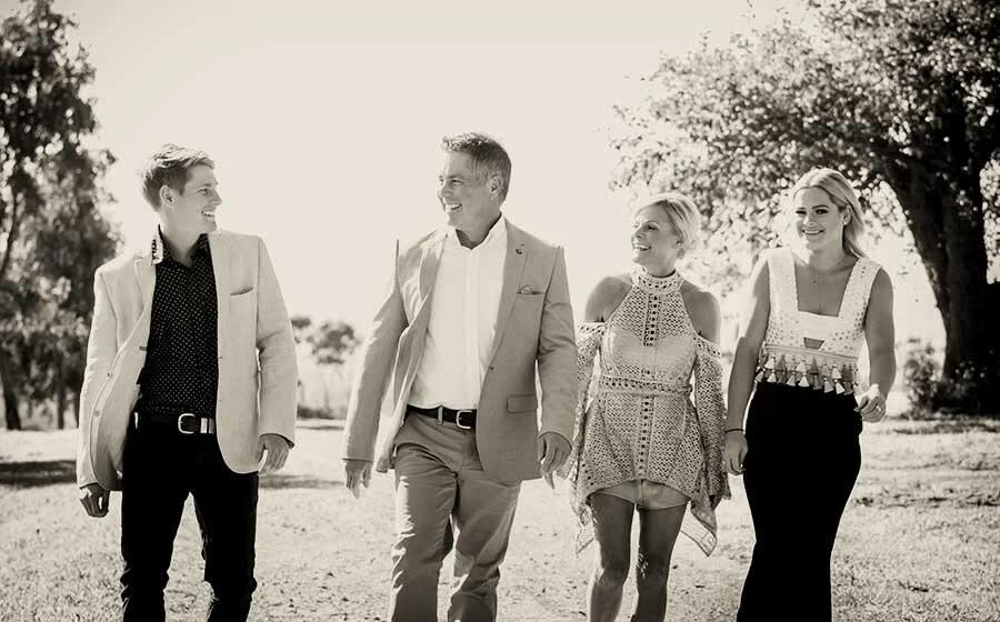 The Beal family walking together through the paddock at Monapilla Estate