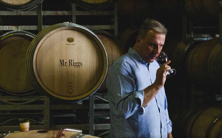 Winemaker Ben Riggs tasting from the barrel in the cellar
